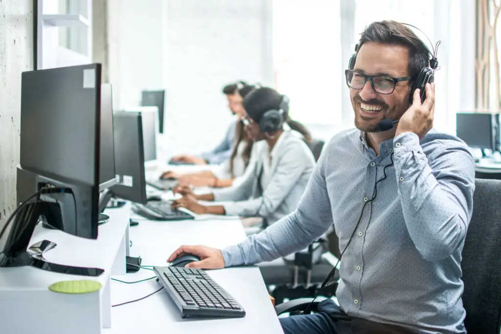 Smiling handsome customer support operator with headset
